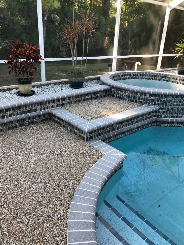 Pool deck in river rock with spa